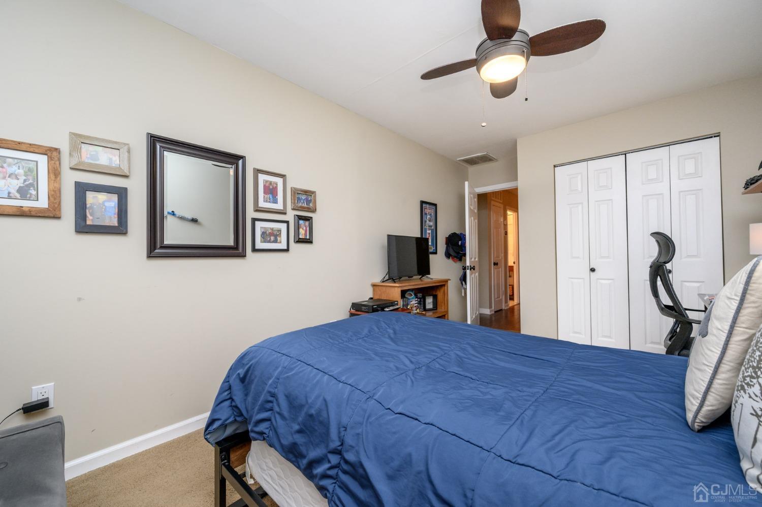 607 Randall Way Aberdeen, NJ 07747 - Photo 25 of 35 a bedroom with a bed and a chandelier