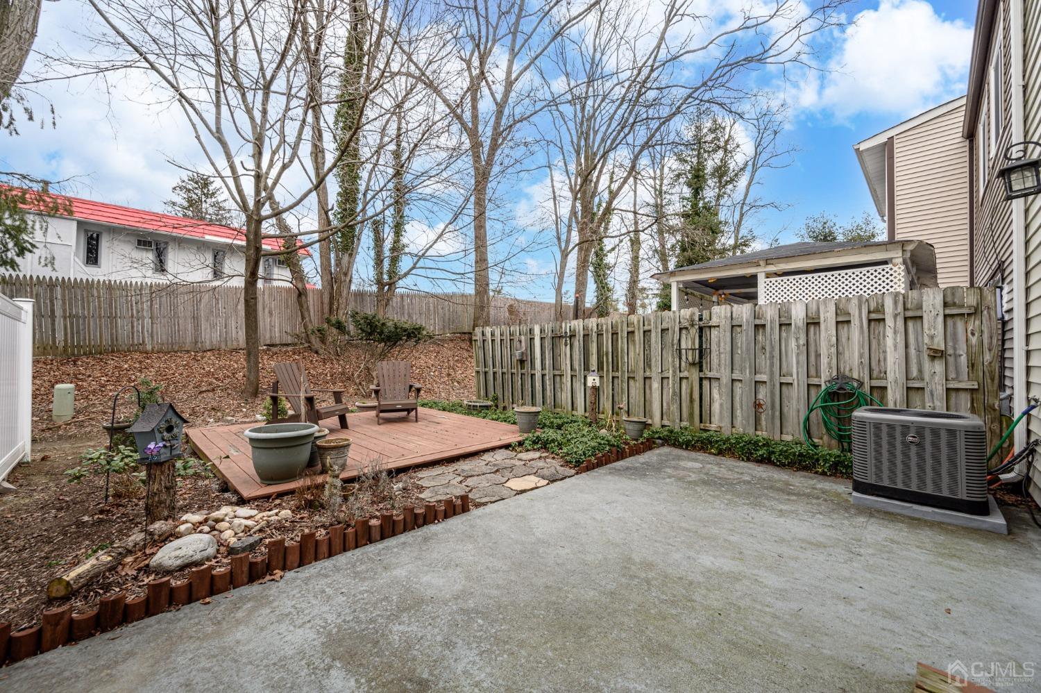607 Randall Way Aberdeen, NJ 07747 - Photo 26 of 35 a view of a backyard with sitting area and fire pit