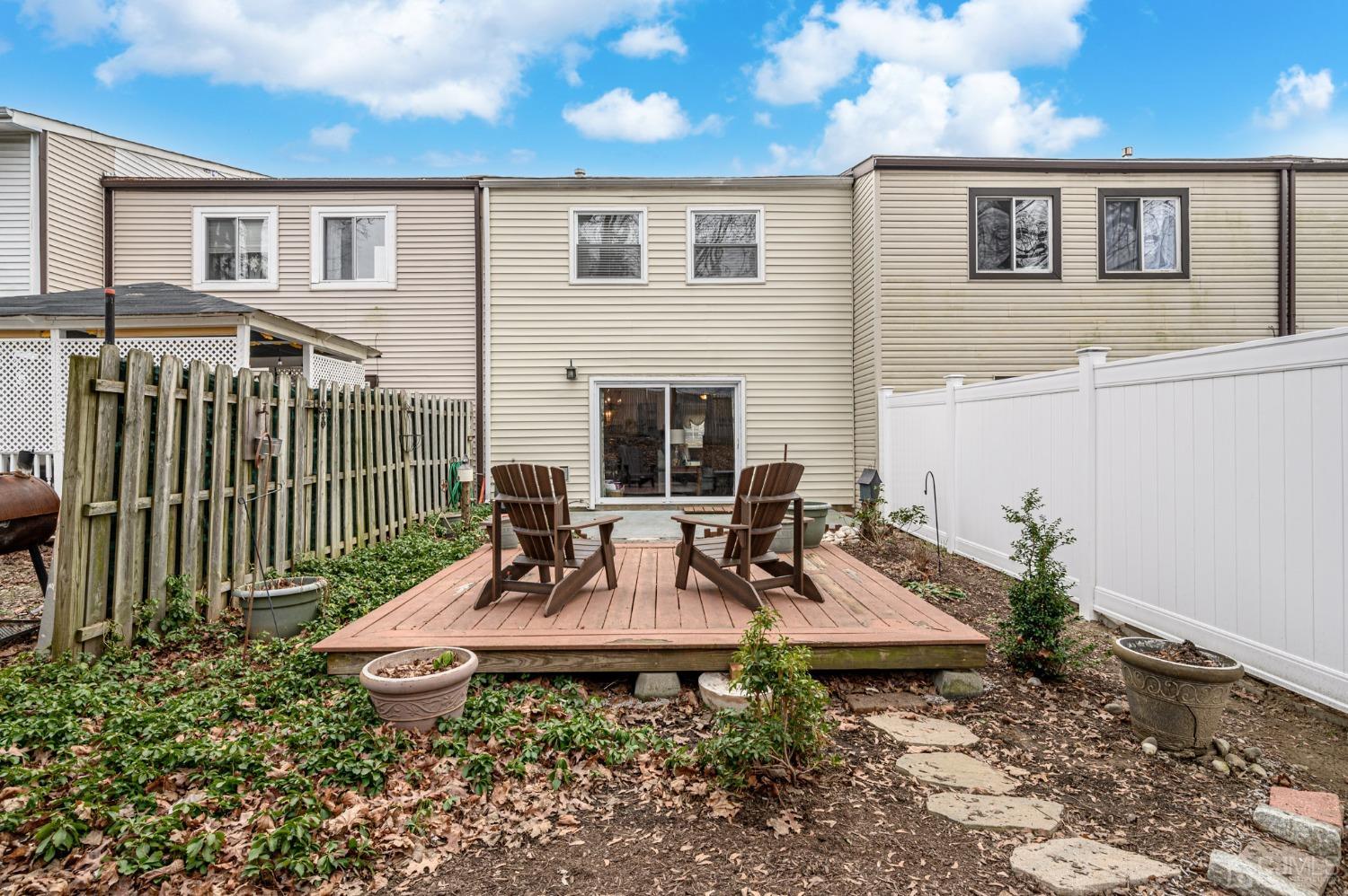 607 Randall Way Aberdeen, NJ 07747 - Photo 28 of 35 a view of a patio with table and chairs and potted plants