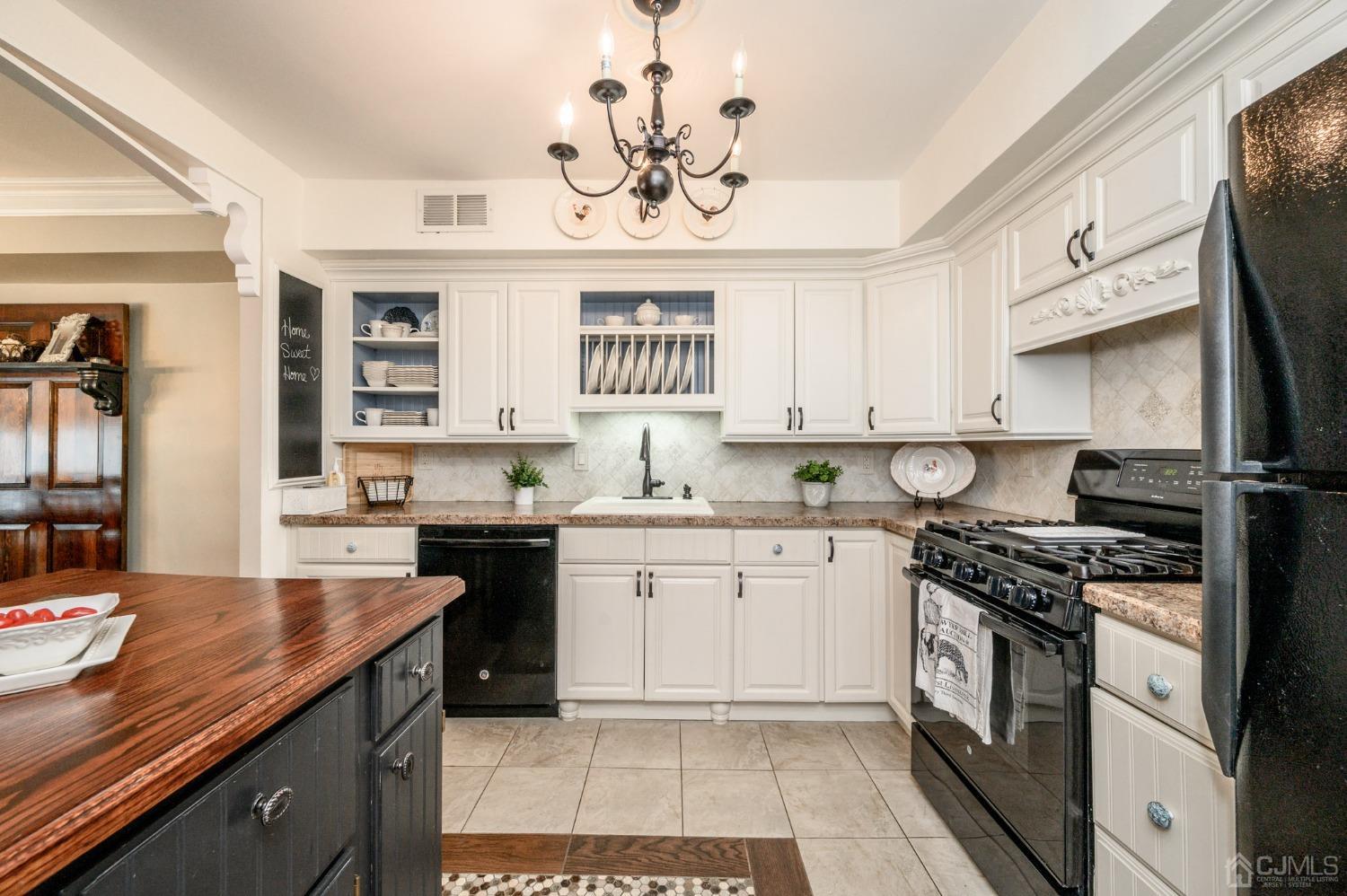 607 Randall Way Aberdeen, NJ 07747 - Photo 5 of 35 a kitchen with a sink cabinets and window