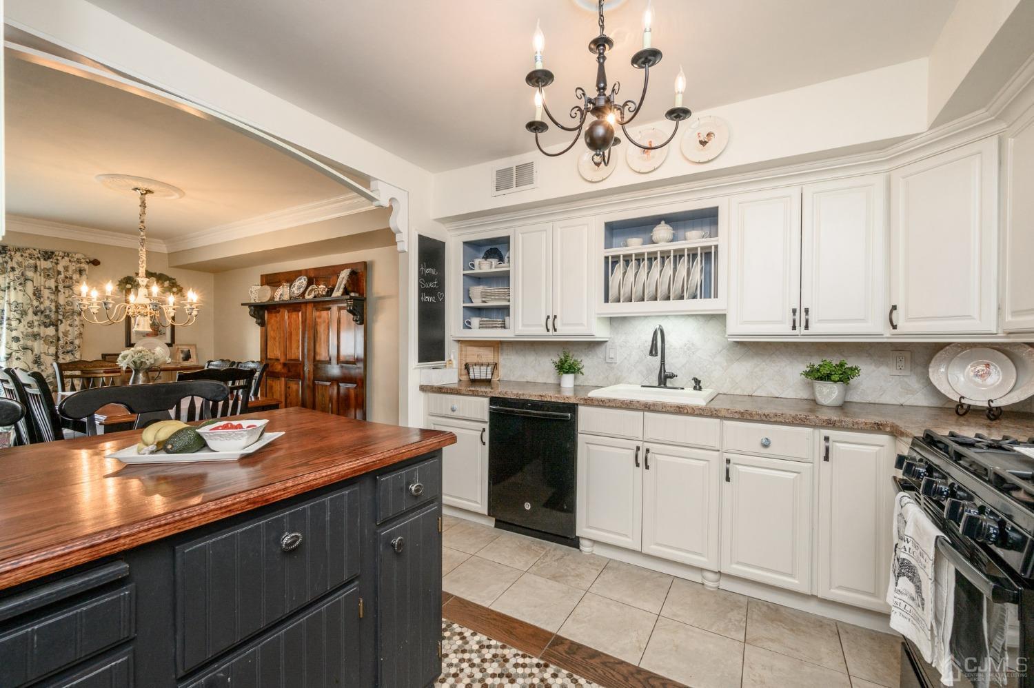 607 Randall Way Aberdeen, NJ 07747 - Photo 6 of 35 a kitchen with a sink dishwasher a stove and white cabinets