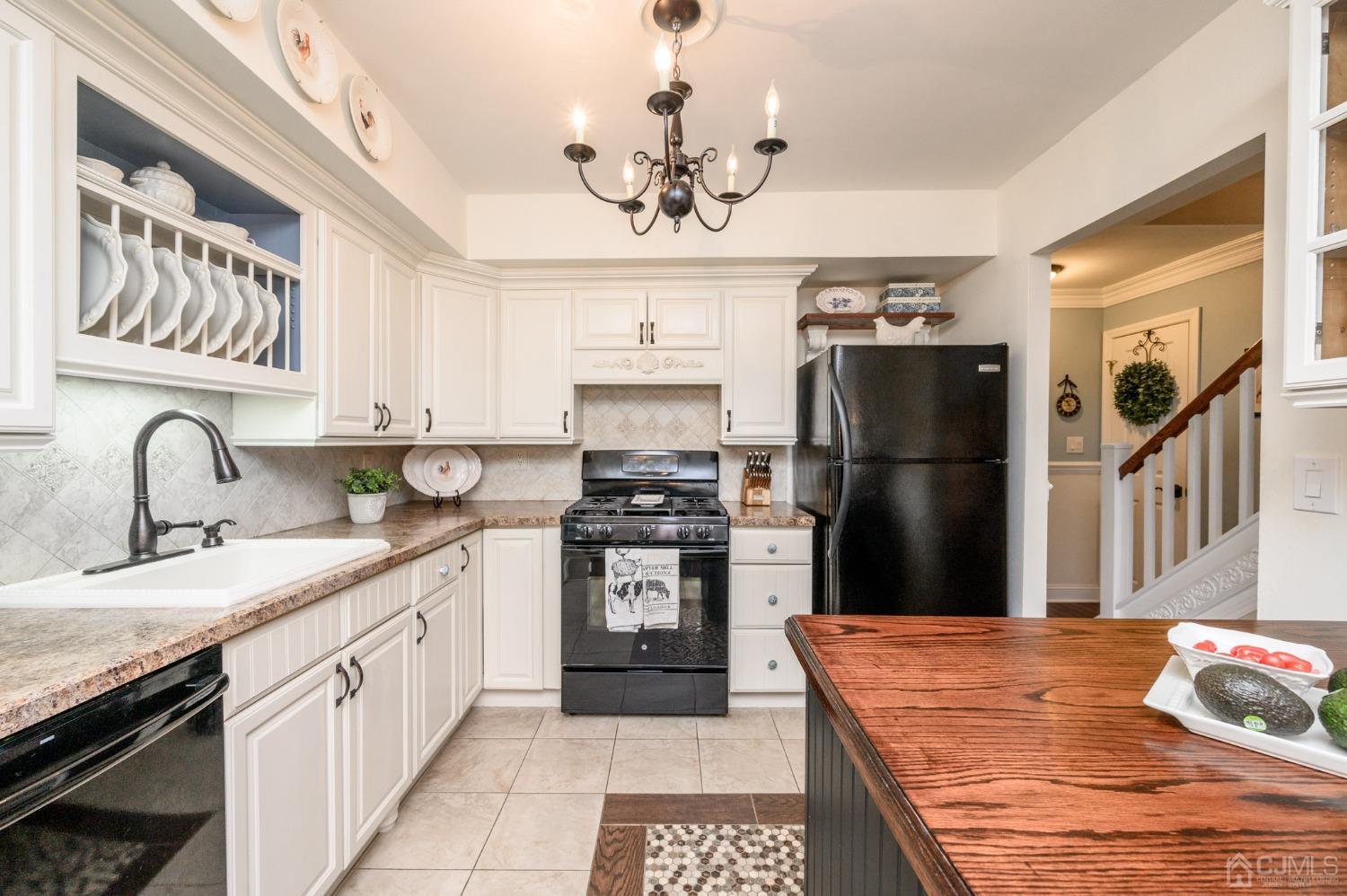 607 Randall Way Aberdeen, NJ 07747 - Photo 7 of 35 a kitchen with stainless steel appliances granite countertop a refrigerator a stove a sink dishwasher and a refrigerator