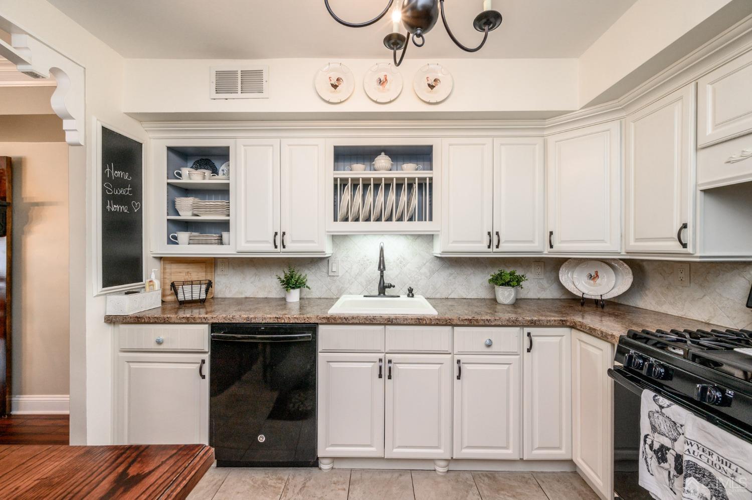 607 Randall Way Aberdeen, NJ 07747 - Photo 10 of 35 a kitchen with stainless steel appliances granite countertop a sink and cabinets