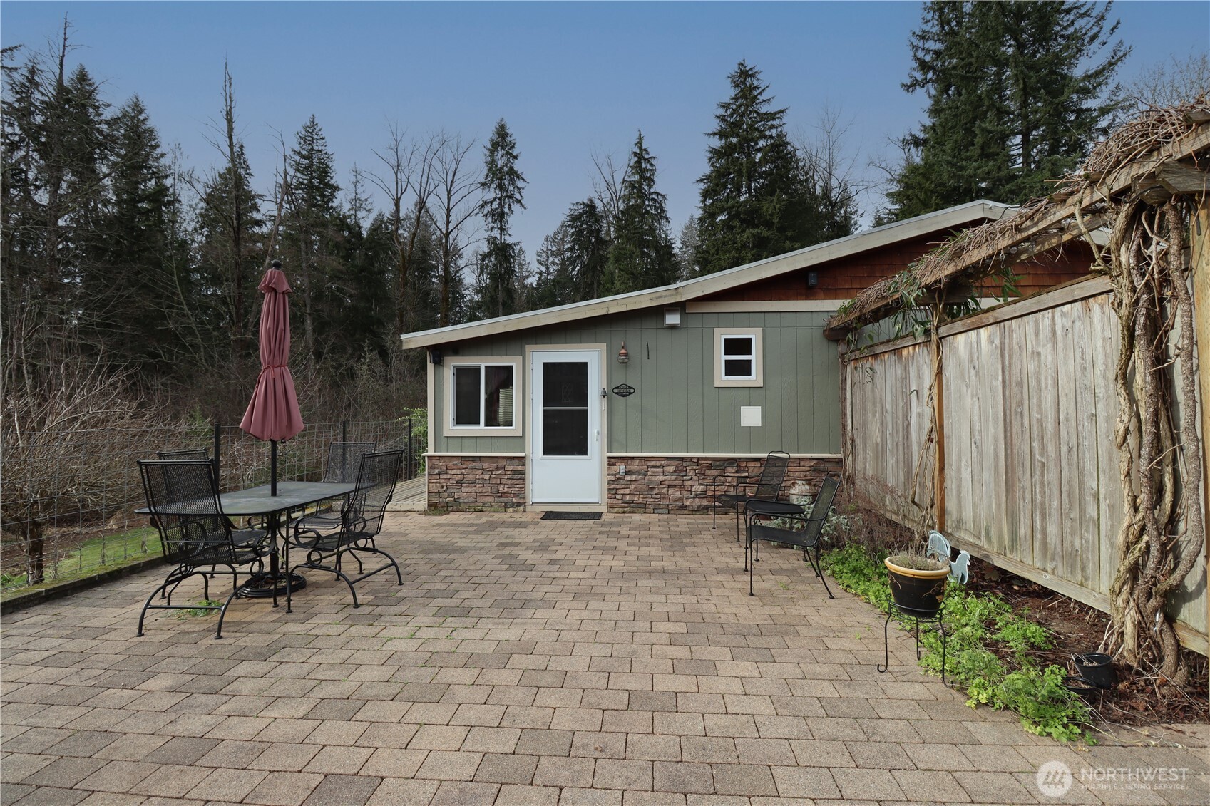 12514 Chain Lake Road Snohomish, WA 98290 - Photo 12 of 27 a backyard of a house with table and chairs