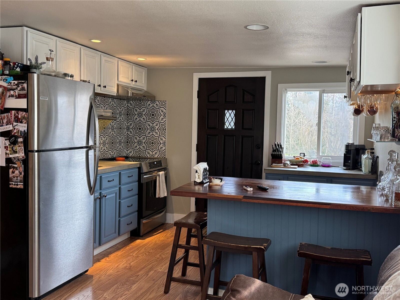 12514 Chain Lake Road Snohomish, WA 98290 - Photo 13 of 27 a kitchen with stainless steel appliances granite countertop a refrigerator and a stove
