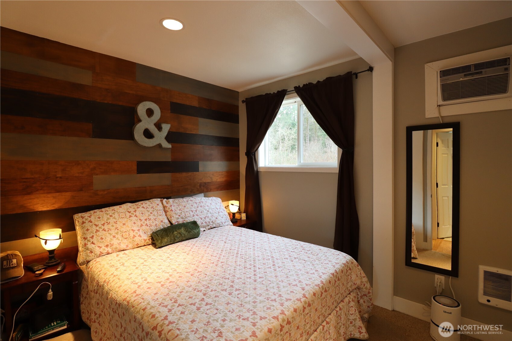 12514 Chain Lake Road Snohomish, WA 98290 - Photo 15 of 27 a bed sitting in a bedroom next to a window
