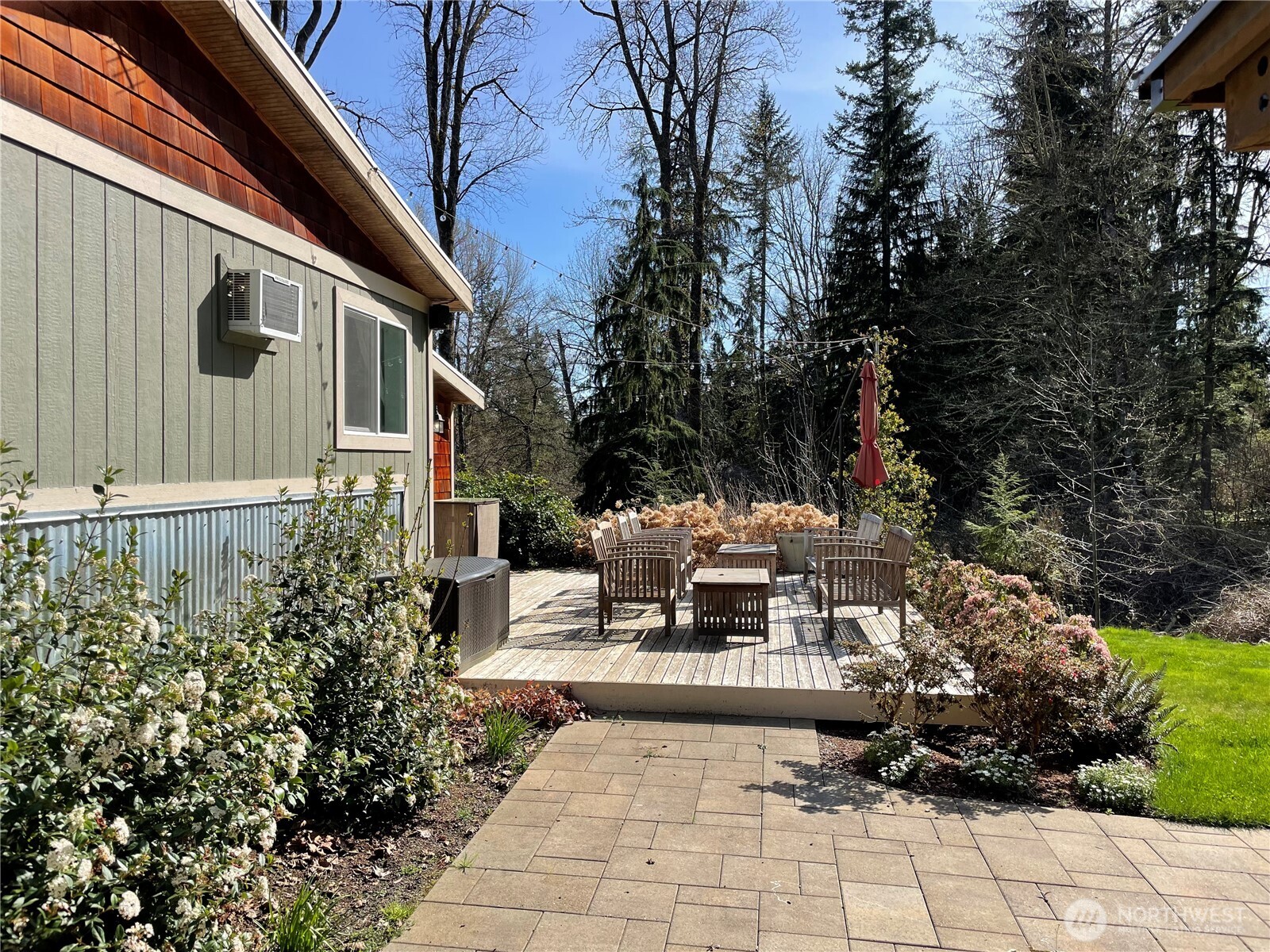 12514 Chain Lake Road Snohomish, WA 98290 - Photo 17 of 27 a view of a patio with table and chairs and potted plants