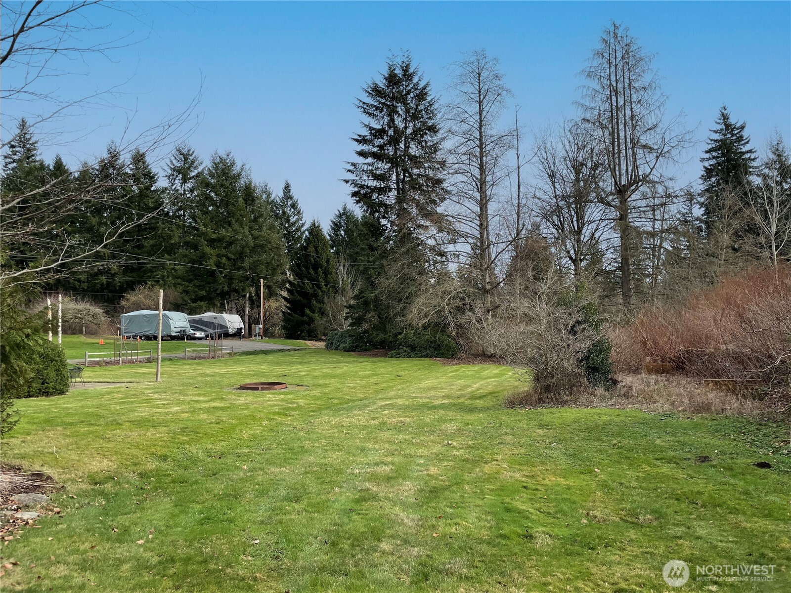 12514 Chain Lake Road Snohomish, WA 98290 - Photo 7 of 27 a swimming pool with trees in the background
