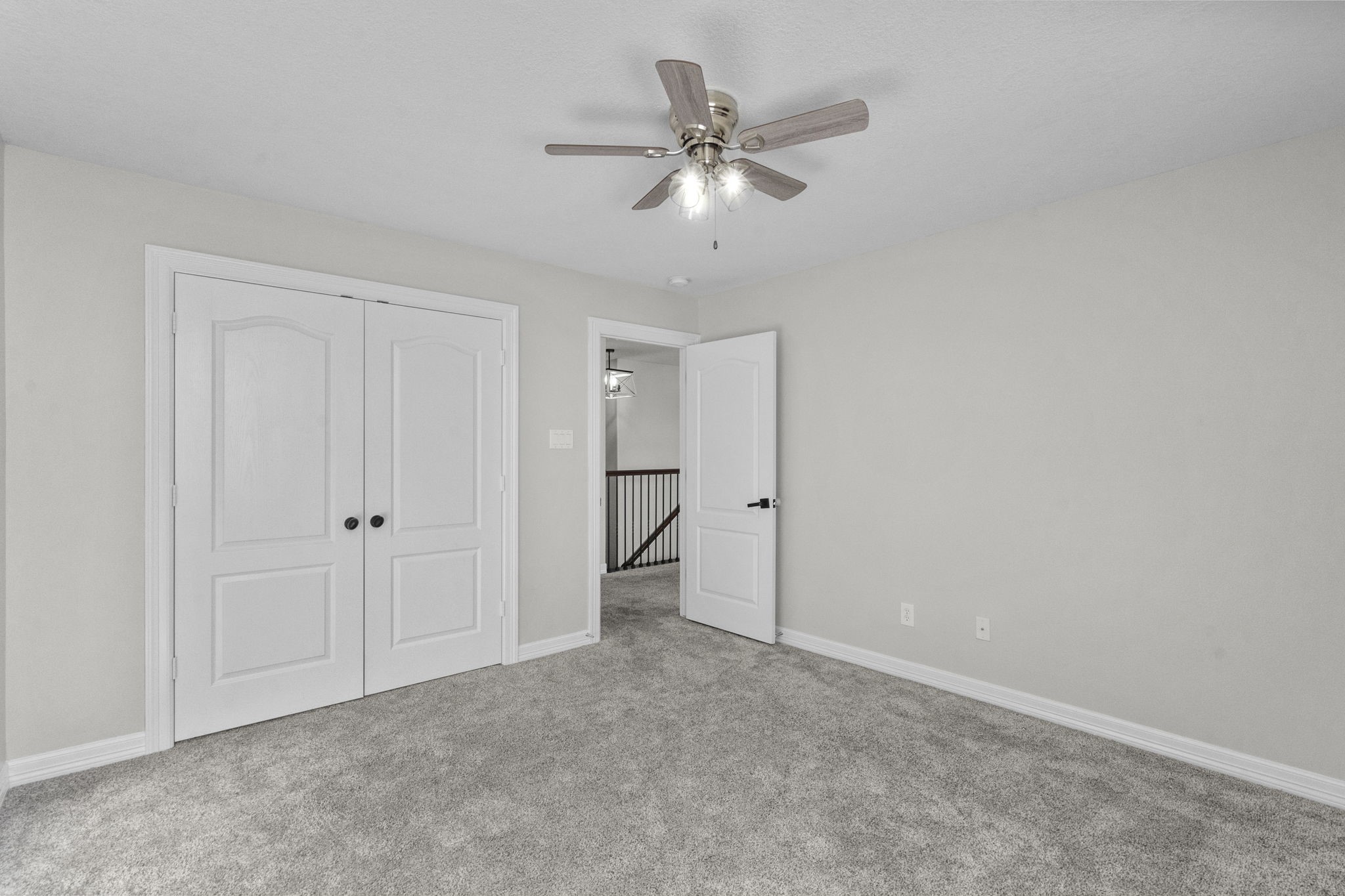 2730 Lawrence Road Kemah, TX 77565 - Photo 32 of 46 This room features neutral walls, plush carpet, a ceiling fan, and double doors for storage. It offers ample natural light and a modern, clean aesthetic.