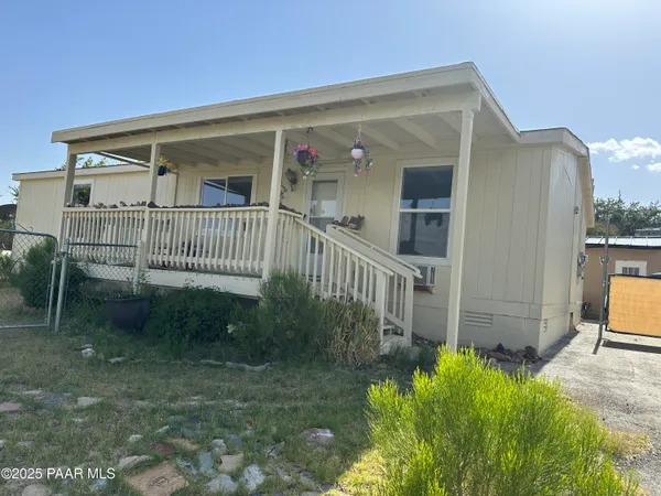 a view of a house with backyard and porch