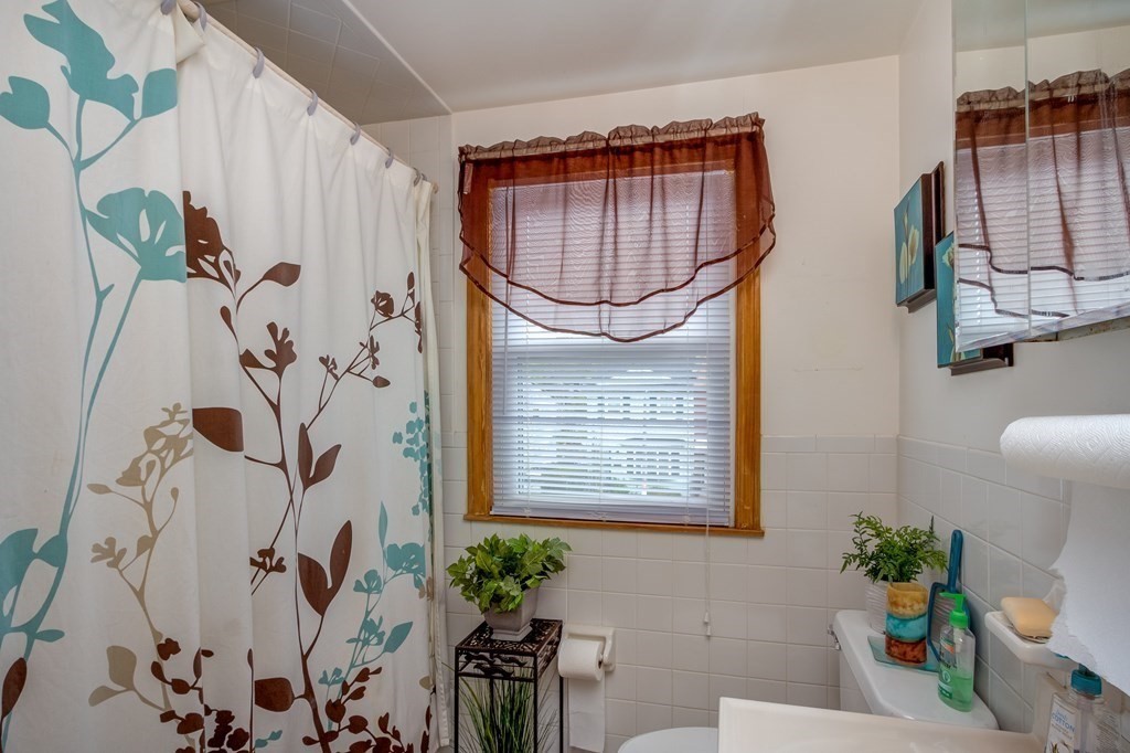 55 Jacob Street Boston, MA 02124 - Photo 14 of 22 a bathroom with a tub sink and mirror