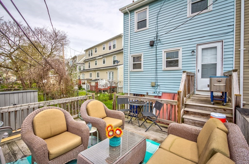 55 Jacob Street Boston, MA 02124 - Photo 20 of 22 a view of a patio with couches chairs and wooden floor
