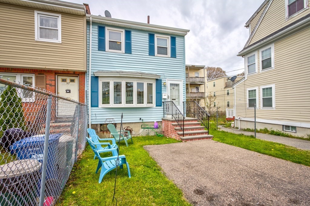 55 Jacob Street Boston, MA 02124 - Photo 2 of 22 a front view of a house with a yard table and chairs