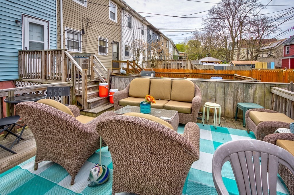 55 Jacob Street Boston, MA 02124 - Photo 21 of 22 a view of a patio with couches chairs and wooden floor