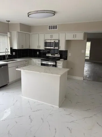 a kitchen with a sink and cabinets