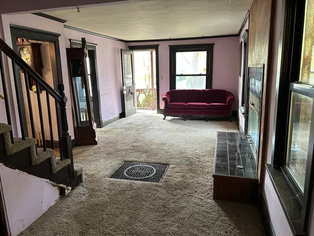 a living room with furniture fireplace and windows
