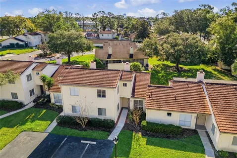 an aerial view of a house with a yard