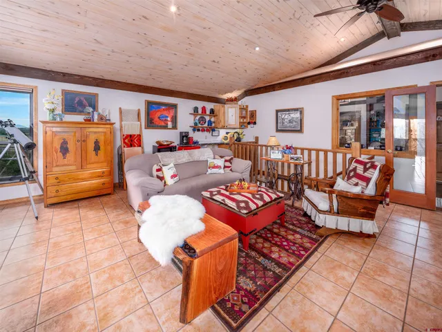 a living room with lots of furniture and a chandelier