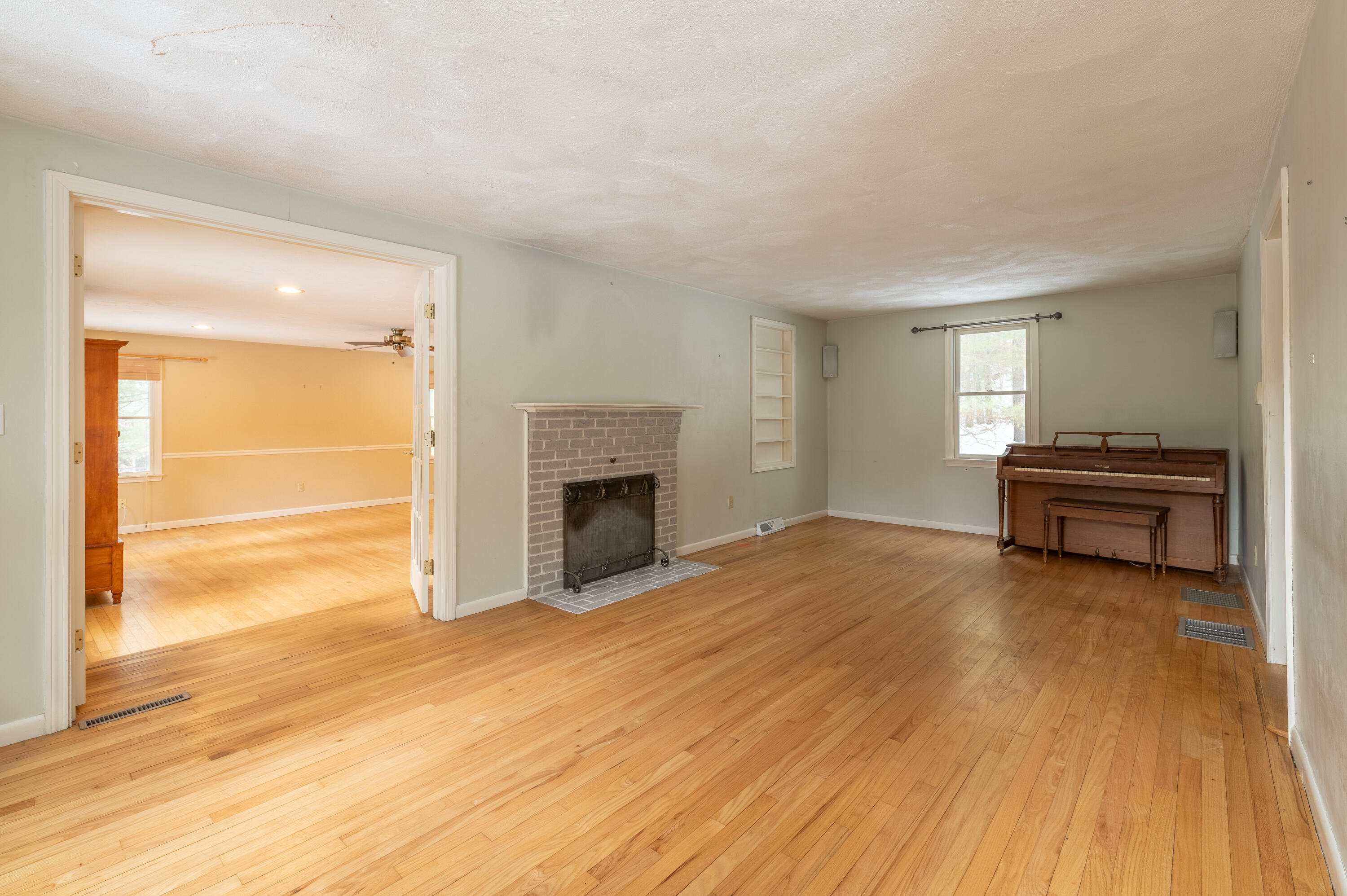 16 Michael Road Pocasset, MA 02559 - Photo 17 of 43 a view of empty room with wooden floor and fireplace