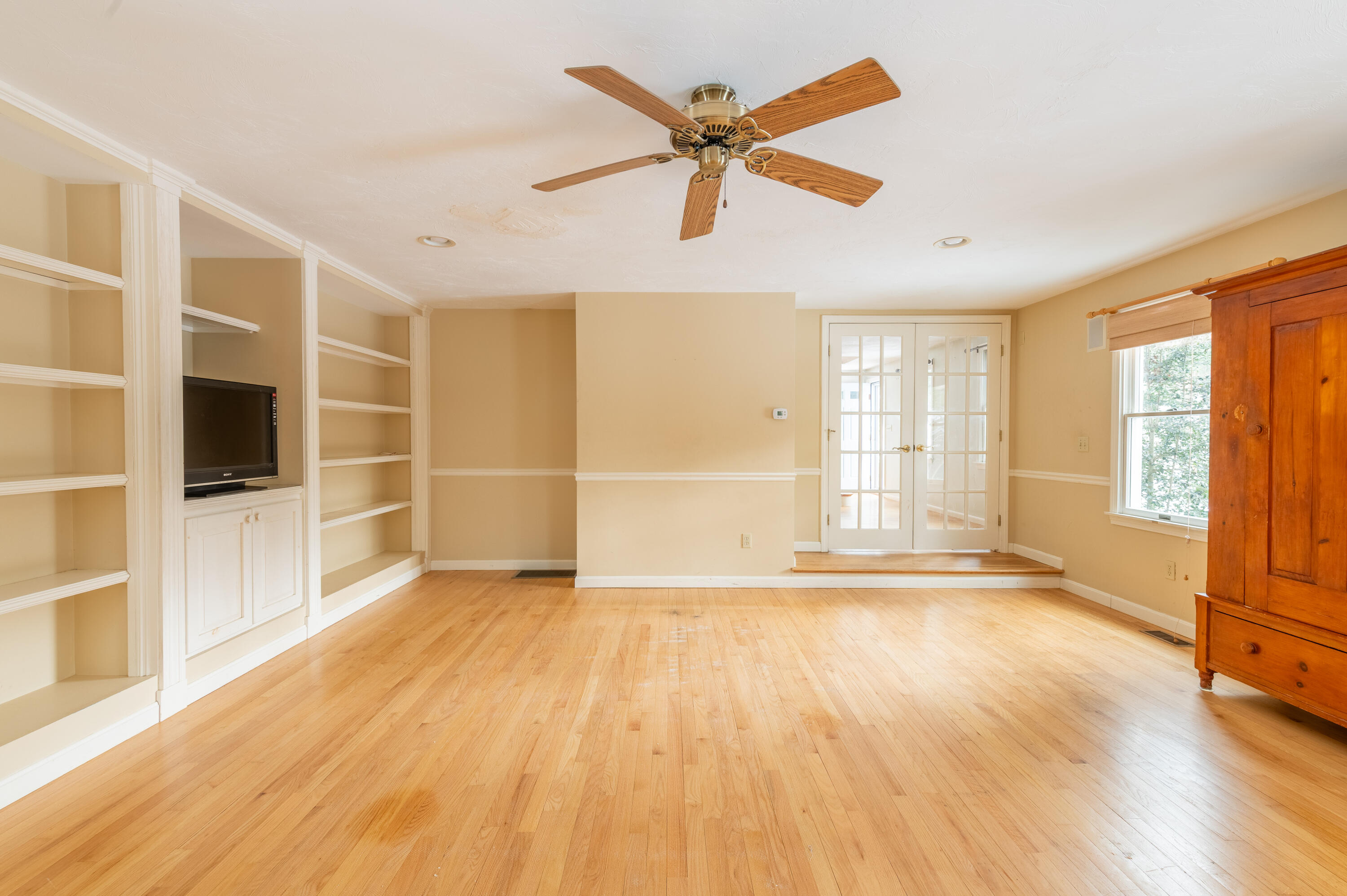 16 Michael Road Pocasset, MA 02559 - Photo 20 of 43 a view of an empty room with a window and wooden floor