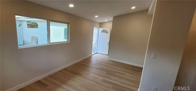 a view of hallway with wooden floor
