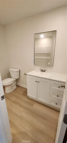 a bathroom with a sink a toilet and mirror