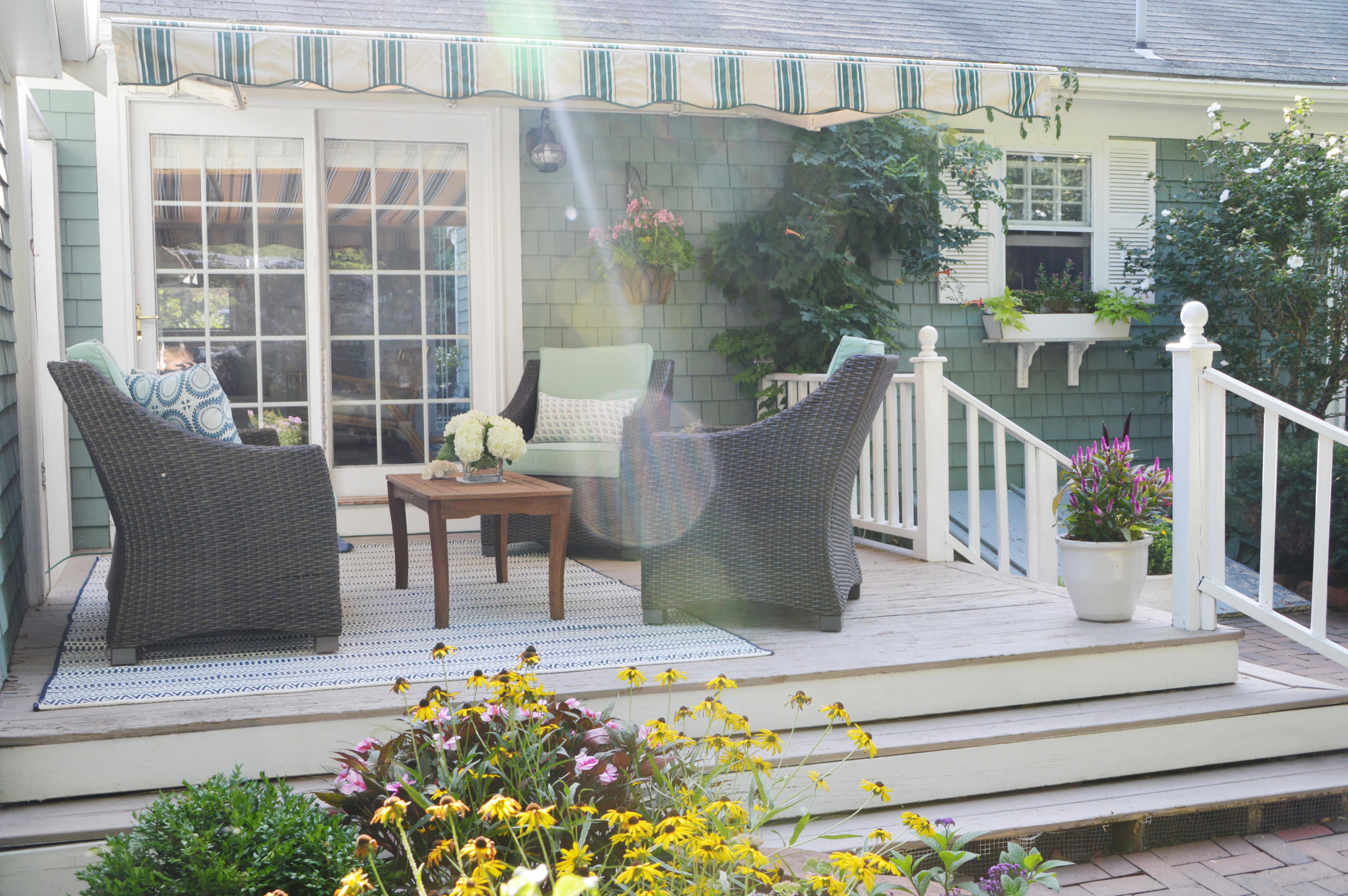 73 Knotty Pine Lane Centerville, MA 02632 - Photo 30 of 34 a view of a patio with couches table and chairs and potted plants