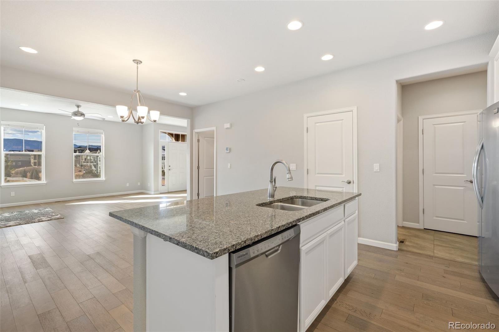 1338 Promontory Bluff View Colorado Springs, CO 80921 - Photo 12 of 28 a kitchen with stainless steel appliances granite countertop a sink and a refrigerator