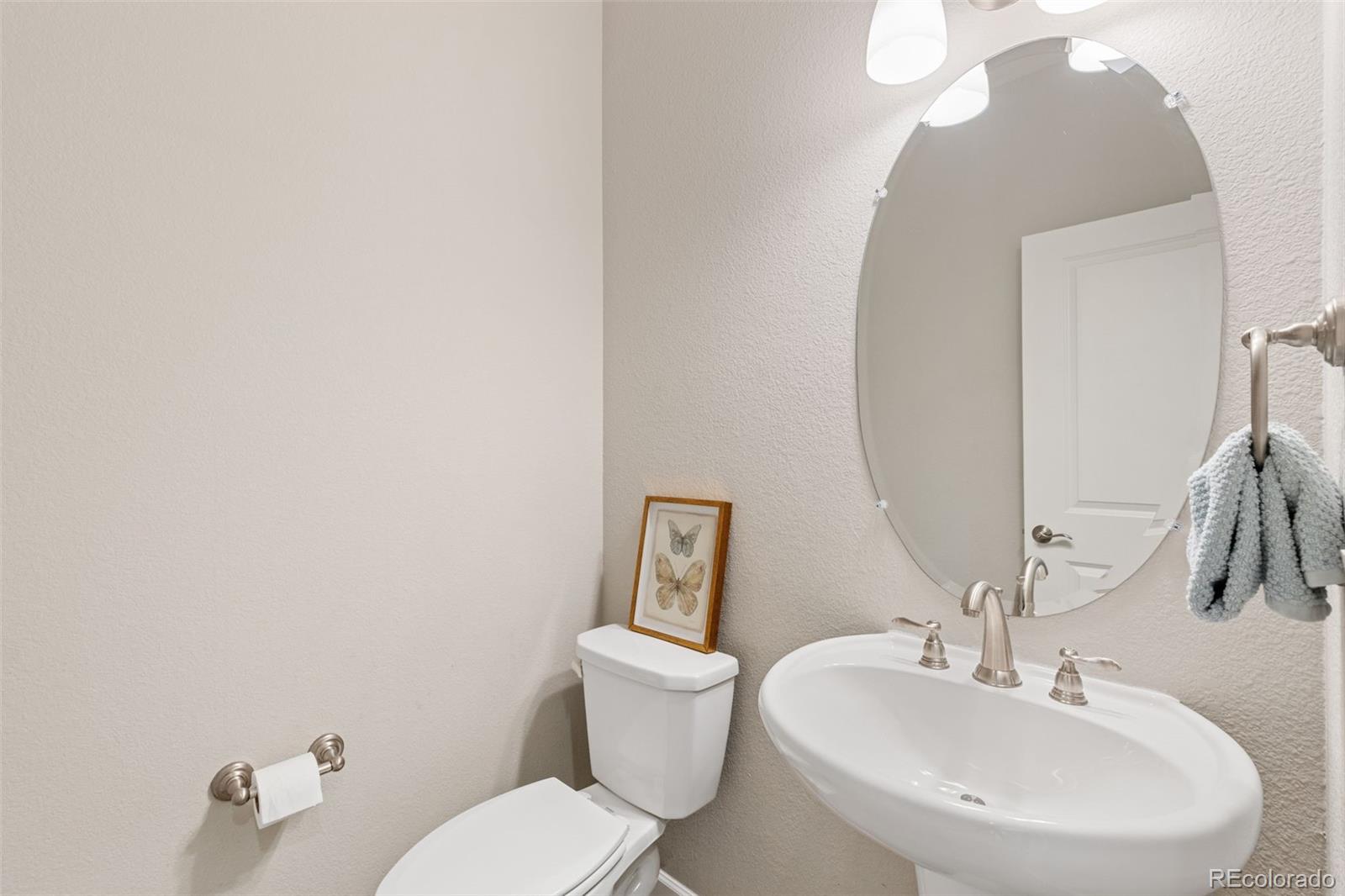 1338 Promontory Bluff View Colorado Springs, CO 80921 - Photo 13 of 28 a bathroom with a toilet sink and mirror