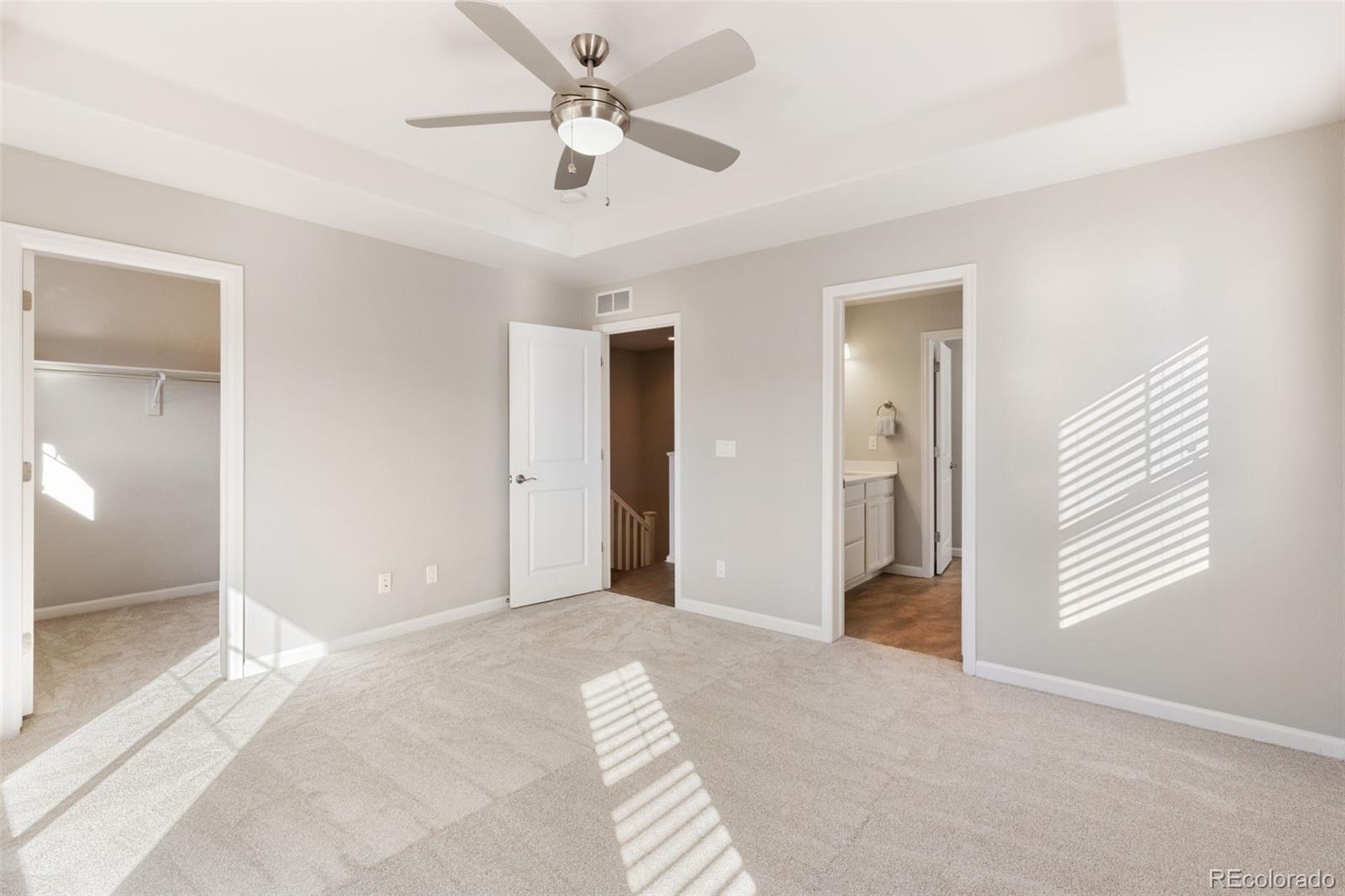 1338 Promontory Bluff View Colorado Springs, CO 80921 - Photo 15 of 28 a view of a room with a ceiling fan and a bathroom