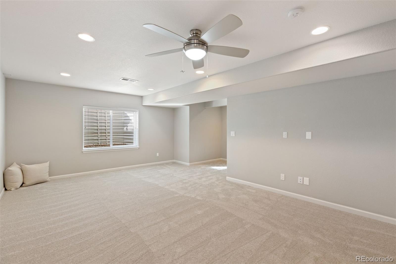 1338 Promontory Bluff View Colorado Springs, CO 80921 - Photo 23 of 28 an empty room with windows and ceiling fan