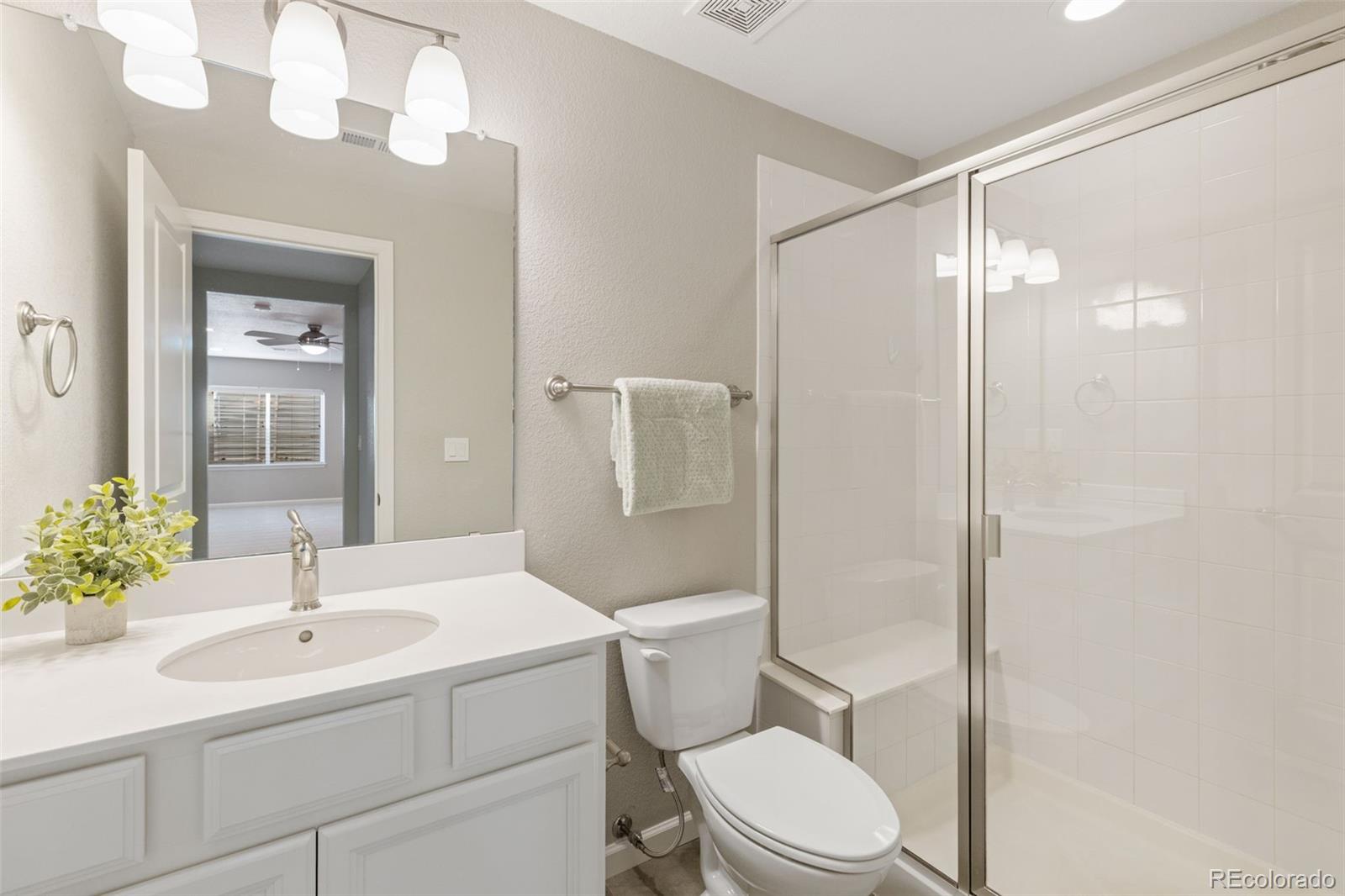 1338 Promontory Bluff View Colorado Springs, CO 80921 - Photo 24 of 28 a bathroom with a sink toilet and shower