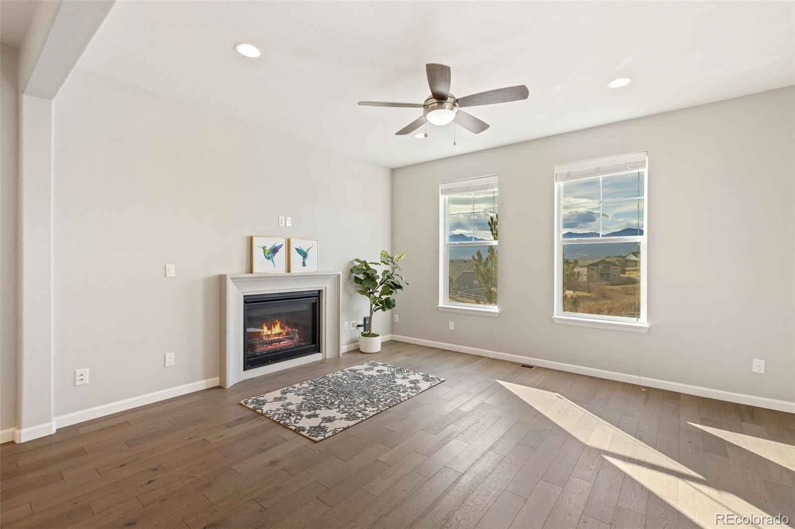 1338 Promontory Bluff View Colorado Springs, CO 80921 - Photo 3 of 28 a view of an empty room with a fireplace and a window