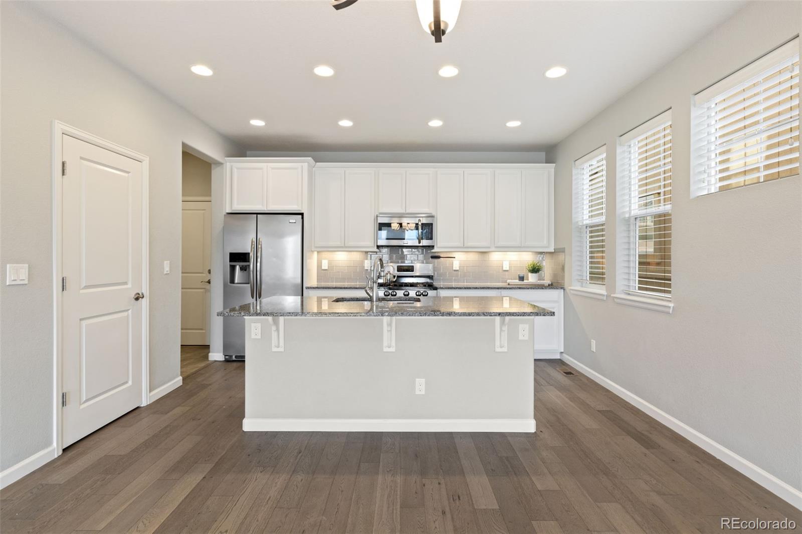 1338 Promontory Bluff View Colorado Springs, CO 80921 - Photo 10 of 28 a view of kitchen with stainless steel appliances granite countertop a stove a sink and a refrigerator
