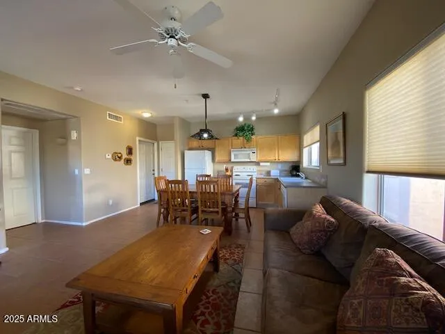 a living room with furniture a large window and chairs