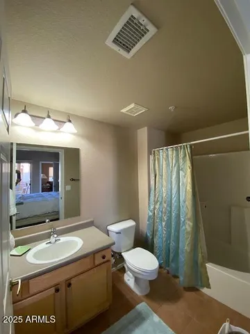 a bedroom with a bed and couch