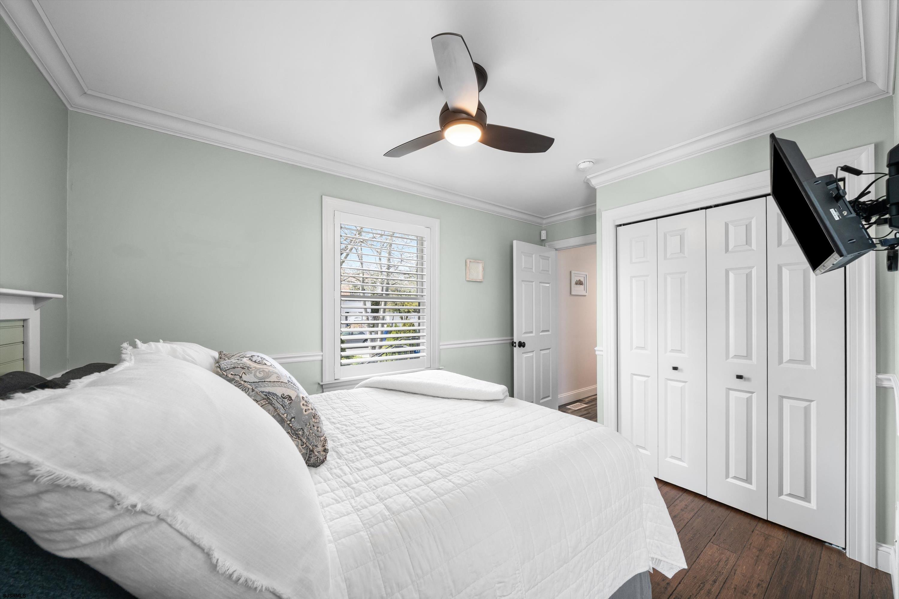 33 Harbor Lane Somers Point, NJ 08244 - Photo 21 of 70 a bedroom with a large bed and a chandelier