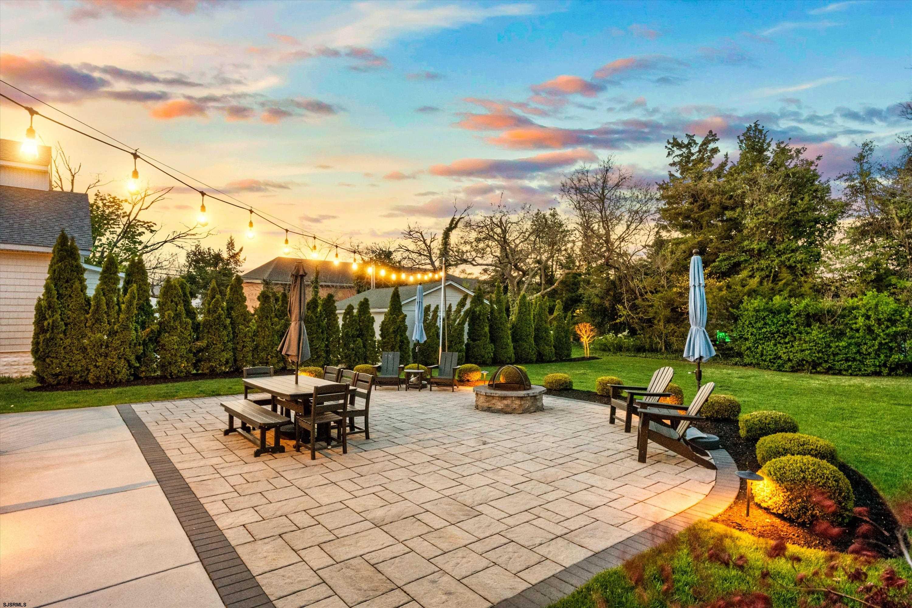 33 Harbor Lane Somers Point, NJ 08244 - Photo 3 of 70 a view of a patio with dining table and chairs with a couches near a garden