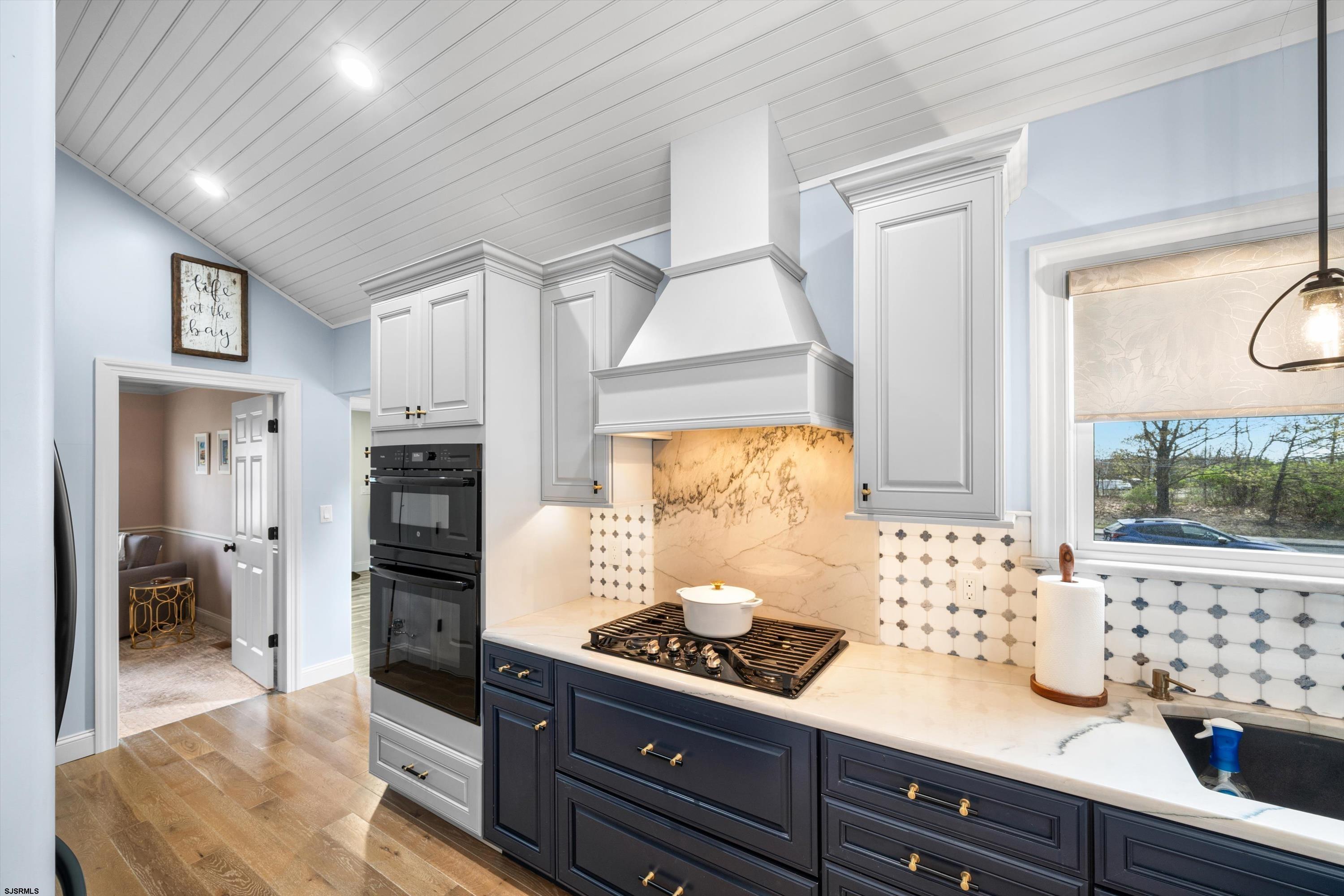 33 Harbor Lane Somers Point, NJ 08244 - Photo 45 of 70 a kitchen with stainless steel appliances kitchen island granite countertop a refrigerator and a stove
