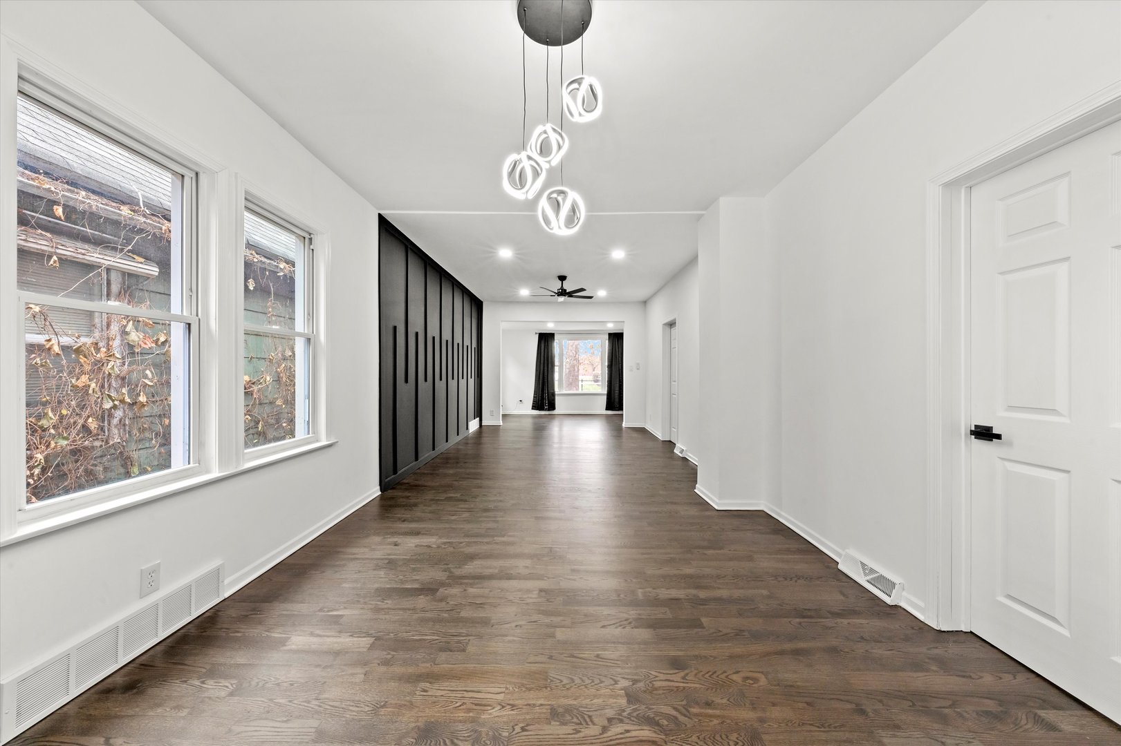 140 West 110th Street Chicago, IL 60628 - Photo 11 of 54 a view of a hallway with wooden floor and a chandelier