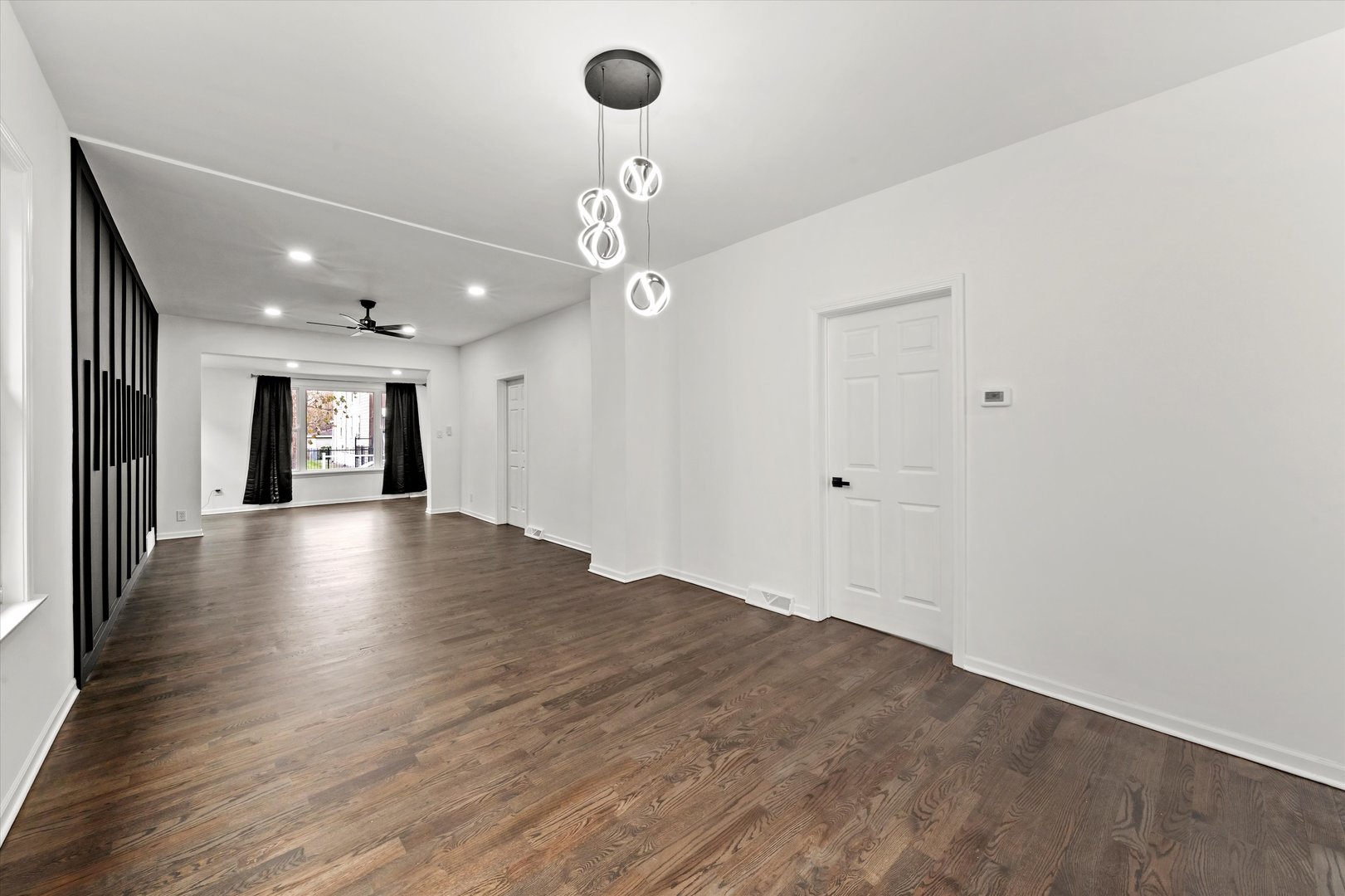 140 West 110th Street Chicago, IL 60628 - Photo 13 of 54 a view of an empty room with wooden floor and a window