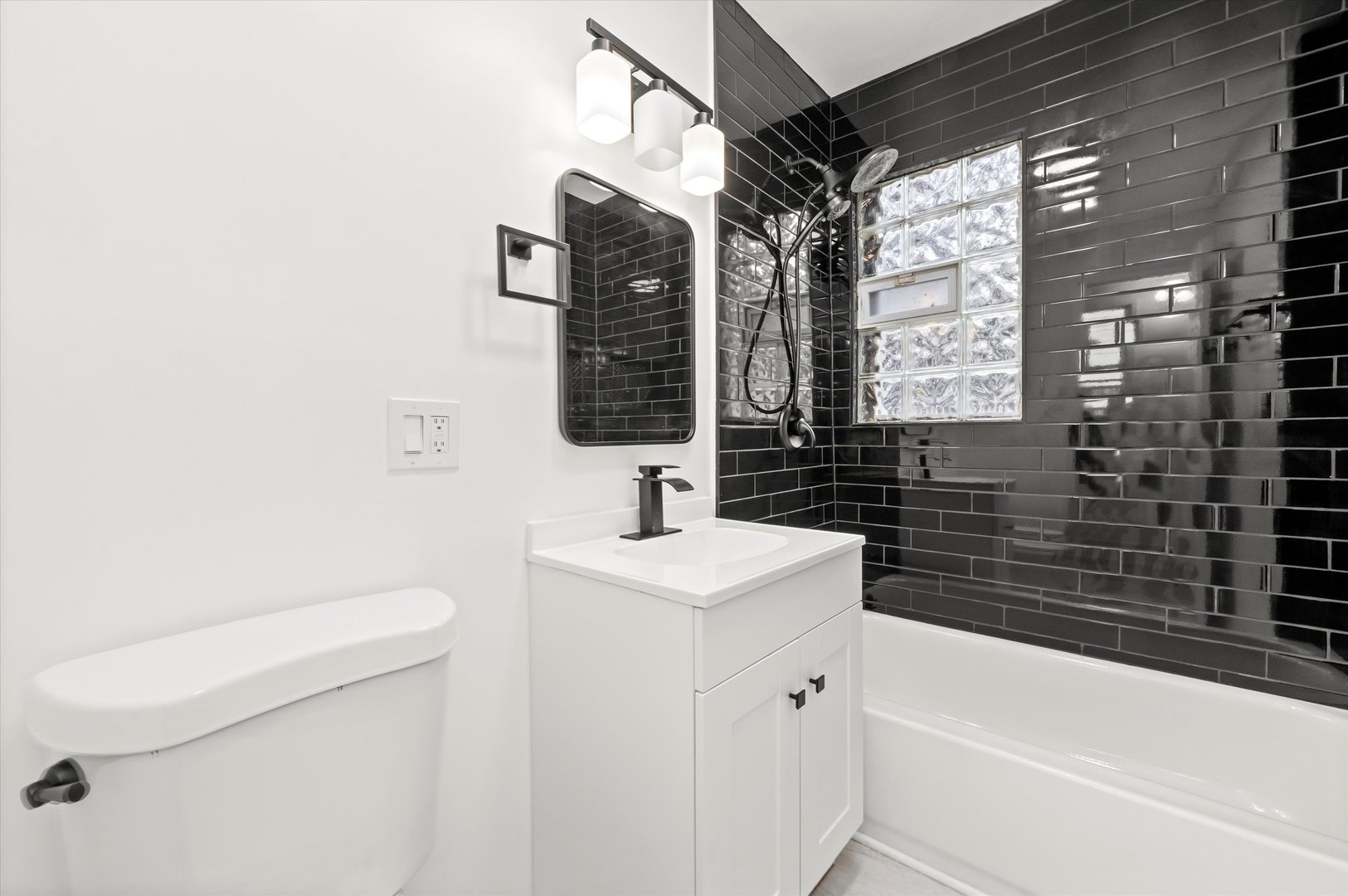 140 West 110th Street Chicago, IL 60628 - Photo 26 of 54 a bathroom with a sink a toilet and bathtub