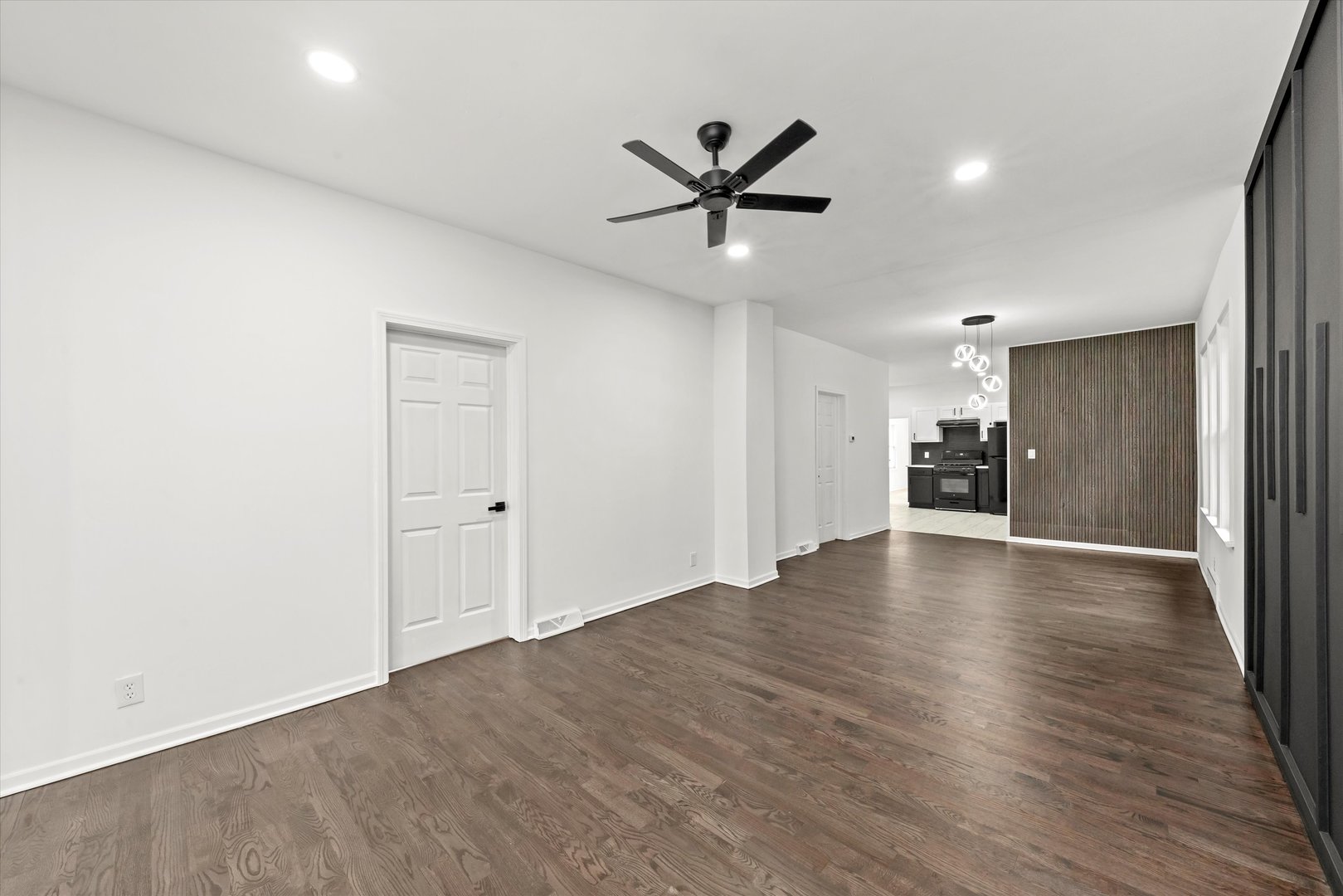 140 West 110th Street Chicago, IL 60628 - Photo 7 of 54 a view of an empty room with wooden floor and a ceiling fan