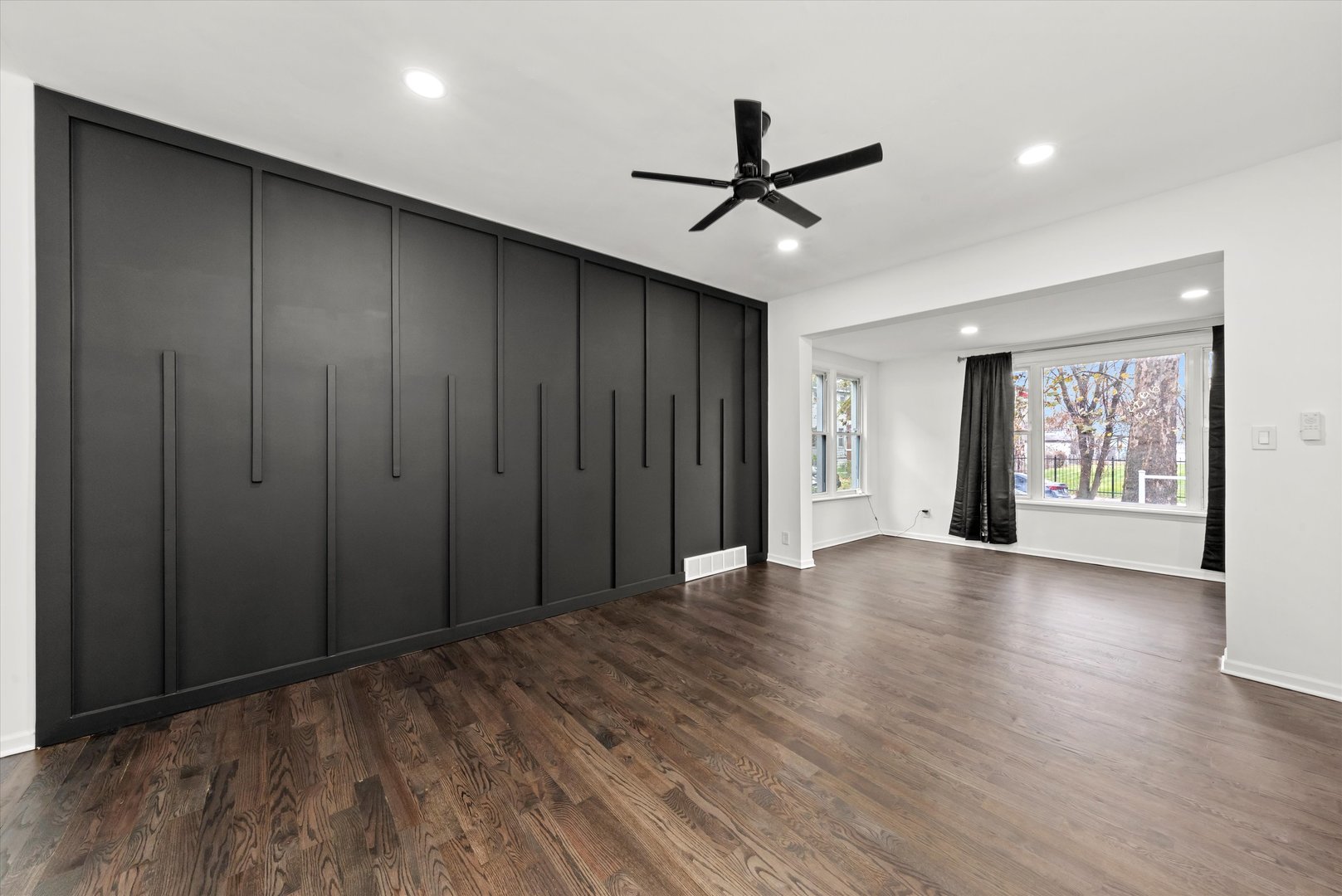 140 West 110th Street Chicago, IL 60628 - Photo 9 of 54 a view of a livingroom with a ceiling fan & windows