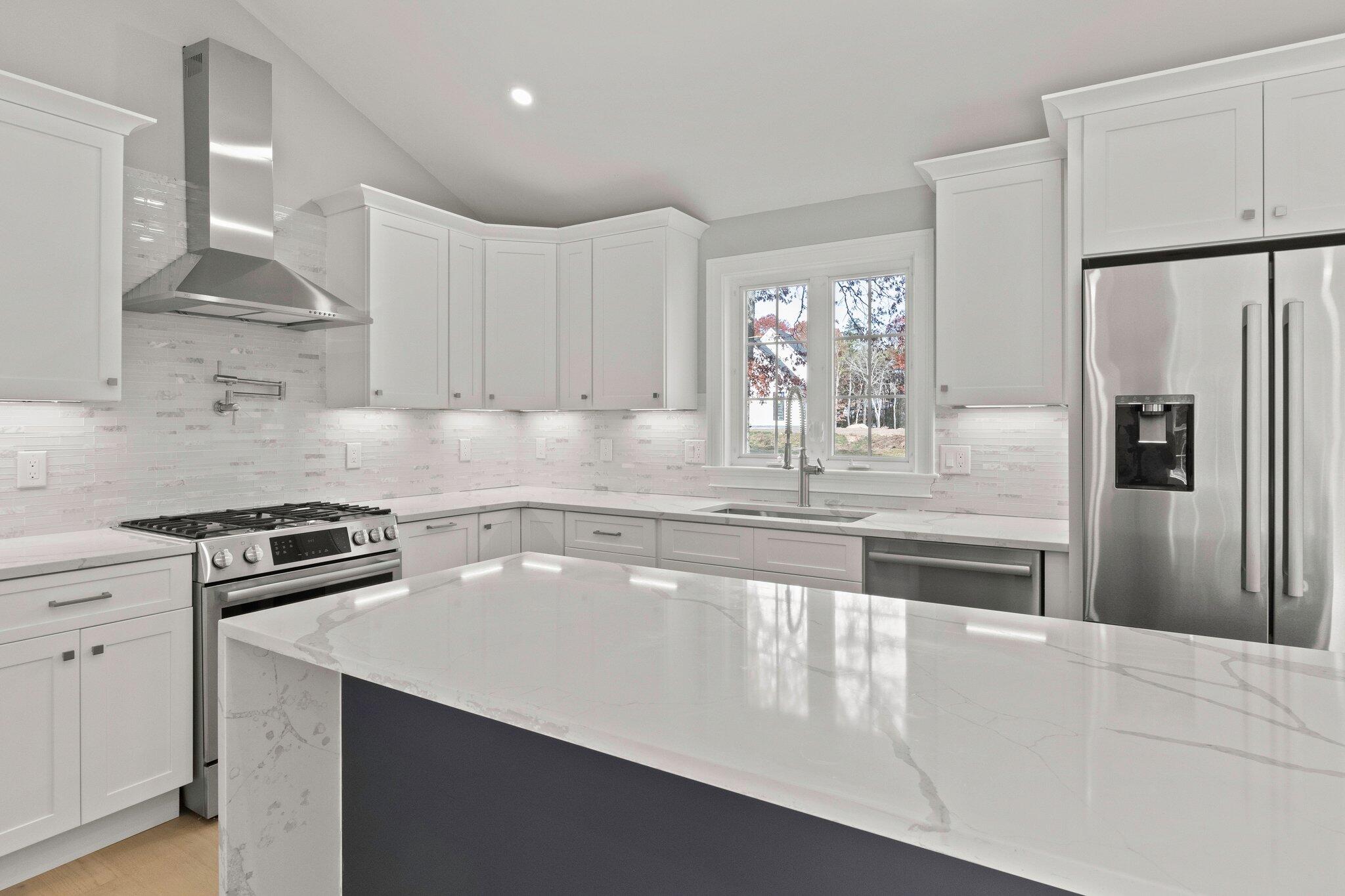 197 Old Barnstable Road Mashpee, MA 02649 - Photo 13 of 50 a kitchen with granite countertop a refrigerator sink and stove