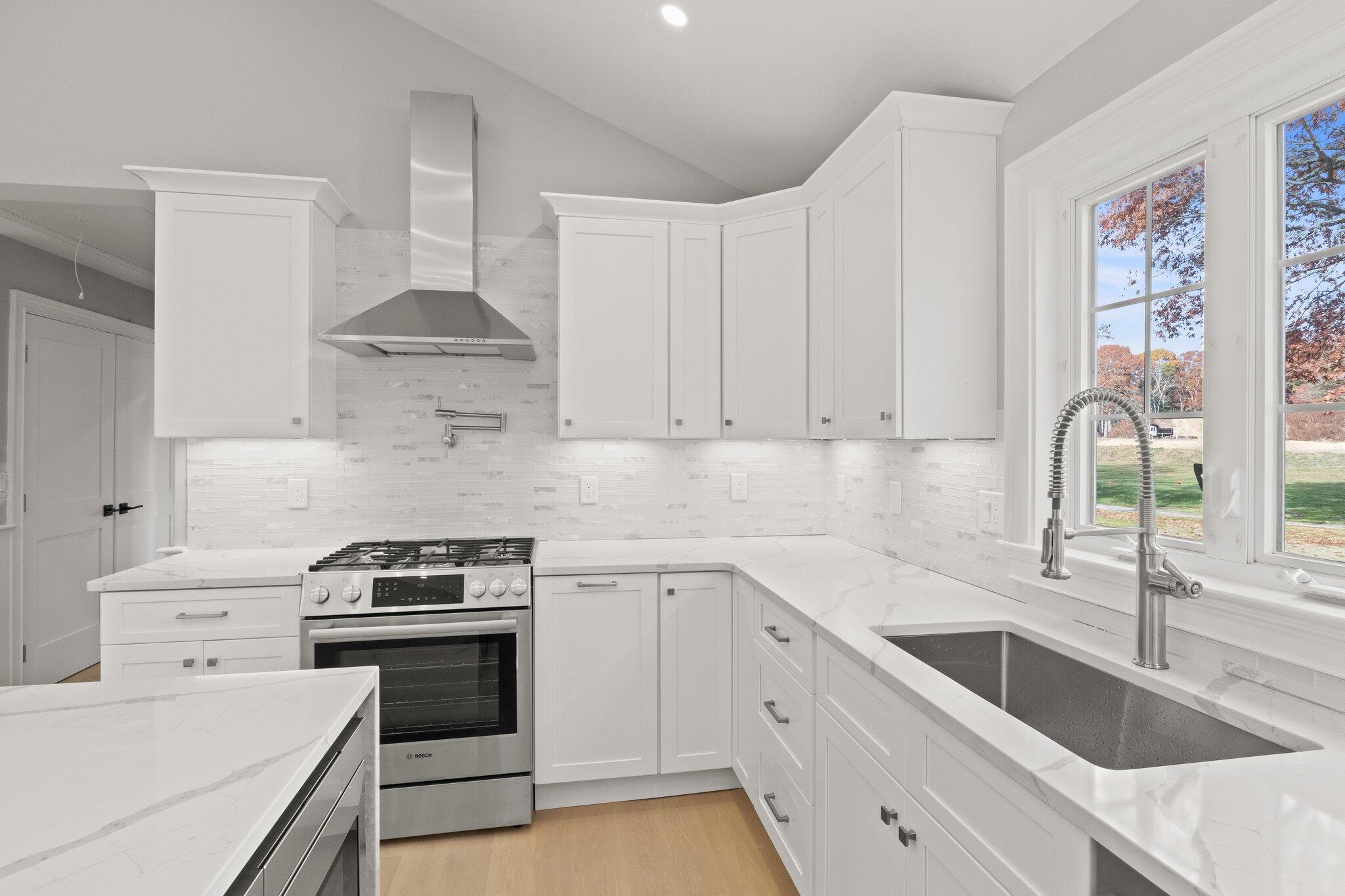 197 Old Barnstable Road Mashpee, MA 02649 - Photo 20 of 50 a kitchen with granite countertop a sink stainless steel appliances and cabinets