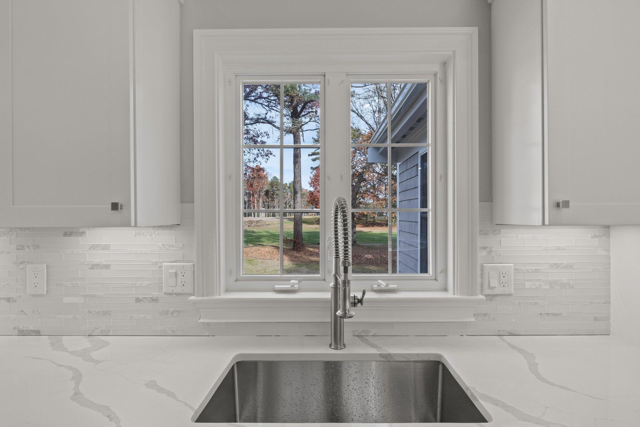 197 Old Barnstable Road Mashpee, MA 02649 - Photo 21 of 50 a bathroom with a bathtub a sink and a window
