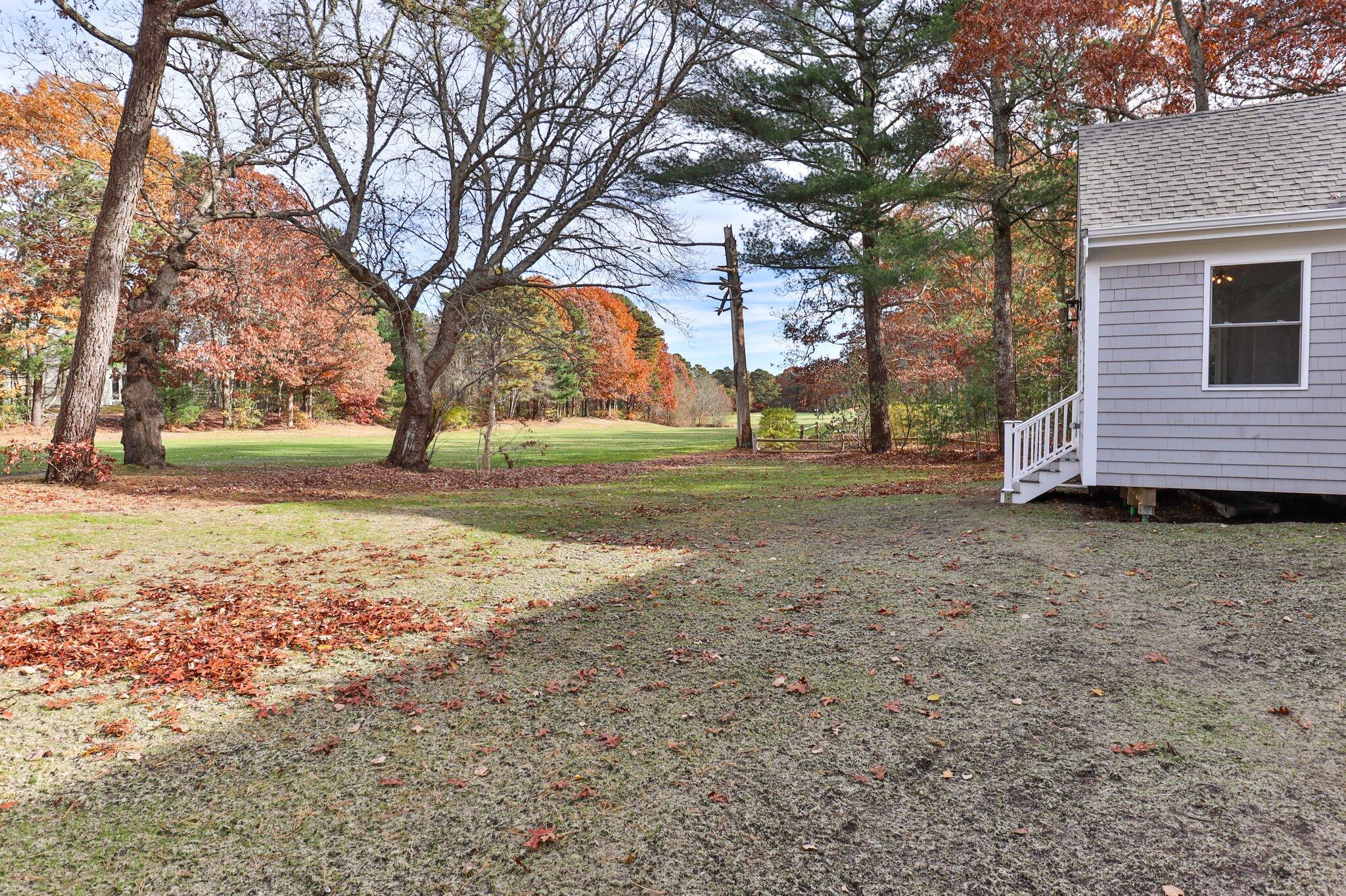 197 Old Barnstable Road Mashpee, MA 02649 - Photo 49 of 50 a view of a yard with a house and a large tree