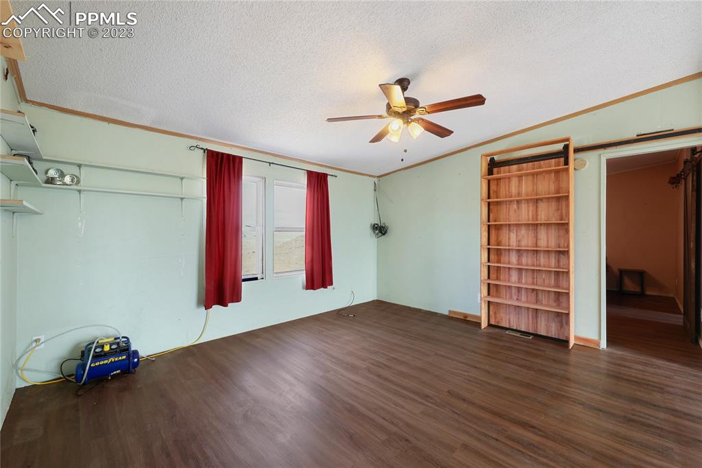 31995 North Neely Road Yoder, CO 80864 - Photo 20 of 46 a view of empty room with wooden floor and fan