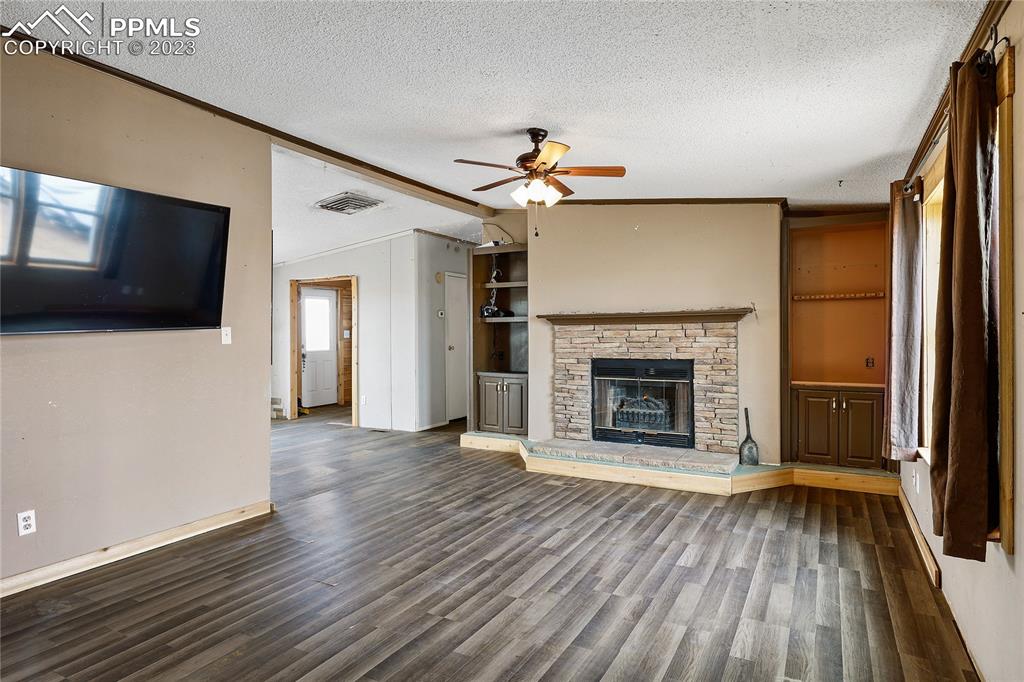 31995 North Neely Road Yoder, CO 80864 - Photo 2 of 46 a view of a livingroom with wooden floor a fireplace and window